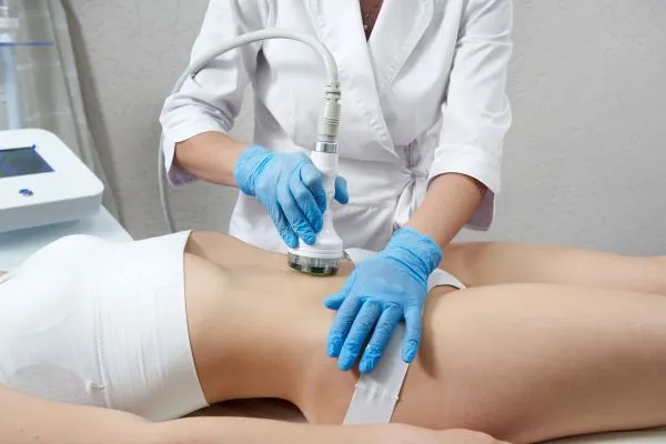 Lost the Weight but Not the Loose Skin? 2 woman having HIFU treatment on her stomach to combat loose skin Bridport following weight loss
